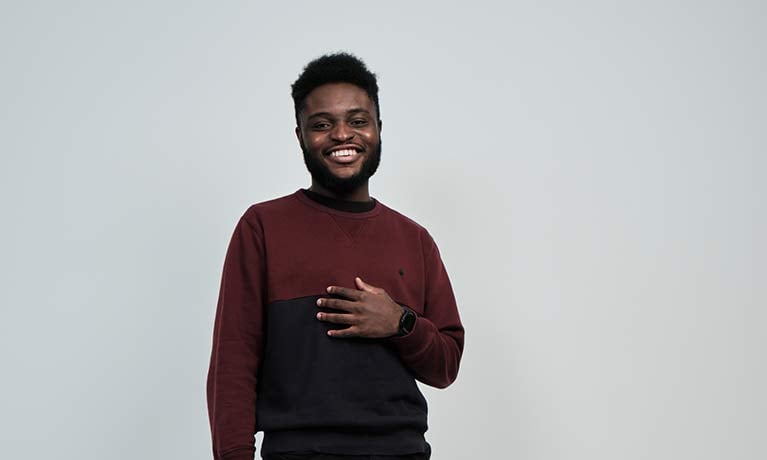 Student Zach Okusi smiling Student Zach Okusi smiling