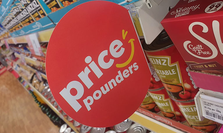 A red sign of a price and savings in a supermarket